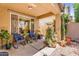 Relaxing covered patio with cozy seating and ample potted plants, perfect for entertaining outdoors at 4355 E Cullumber St, Gilbert, AZ 85234
