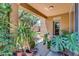 Covered patio with lush greenery, offering a tranquil outdoor living space with views of the backyard at 4355 E Cullumber St, Gilbert, AZ 85234