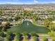 Aerial view of a tranquil pond with a central fountain and shaded seating areas, enhancing the community's outdoor appeal at 4355 E Cullumber St, Gilbert, AZ 85234