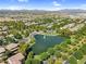 Community aerial view of a serene pond with a fountain, shaded seating, and surrounding green space, offering a picturesque retreat at 4355 E Cullumber St, Gilbert, AZ 85234
