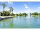 Scenic pond with a fountain, palm trees, and walking paths, offering a tranquil outdoor space at 4355 E Cullumber St, Gilbert, AZ 85234