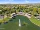 Scenic aerial shot of a community pond with a fountain and covered seating, perfect for relaxation and outdoor enjoyment at 4355 E Cullumber St, Gilbert, AZ 85234