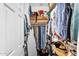 Walk-in closet filled with clothes, an ironing board, and multiple storage options at 4355 E Cullumber St, Gilbert, AZ 85234