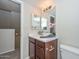 Compact bathroom includes a white sink, a mirror, and a toilet with a wood cabinet at 4730 W Northern Ave # 1141, Glendale, AZ 85301