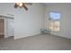 Spacious bedroom features high ceilings, a ceiling fan, and natural light from a large window at 4730 W Northern Ave # 1141, Glendale, AZ 85301