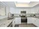 Modern kitchen featuring granite countertops, stainless steel appliances, and white cabinetry at 4730 W Northern Ave # 1141, Glendale, AZ 85301