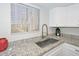 Modern kitchen sink with granite countertops and white cabinets at 4730 W Northern Ave # 1141, Glendale, AZ 85301