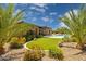 Lush backyard with artificial grass, desert landscaping, and covered patio, perfect for outdoor living at 5330 S Big Horn Pl, Chandler, AZ 85249