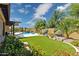 A private backyard featuring a swimming pool, artificial grass, landscaping, and a covered patio at 5330 S Big Horn Pl, Chandler, AZ 85249