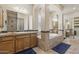 Bathroom featuring double sinks, tiled bathtub, large mirror and tiled floors at 5330 S Big Horn Pl, Chandler, AZ 85249