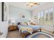 Charming bedroom with a queen bed, ceiling fan, and plantation shutters at 5330 S Big Horn Pl, Chandler, AZ 85249