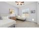 Bedroom showcasing two twin beds, ceiling fan, and a sun-filled window at 5330 S Big Horn Pl, Chandler, AZ 85249