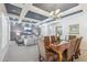 Elegant dining area showcasing coffered ceilings and seamless flow to the living room, ideal for entertaining at 5330 S Big Horn Pl, Chandler, AZ 85249