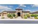 Charming home exterior featuring a stone archway, manicured landscaping, and a well-maintained yard at 5330 S Big Horn Pl, Chandler, AZ 85249