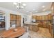 Open kitchen featuring wooden cabinetry, granite countertops, stainless steel appliances, and adjacent dining area at 5330 S Big Horn Pl, Chandler, AZ 85249