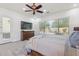 Main bedroom with large window, ceiling fan, rug, dresser and access to the backyard at 5330 S Big Horn Pl, Chandler, AZ 85249