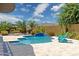 A blue swimming pool surrounded by manicured landscaping and a tiled deck at 5330 S Big Horn Pl, Chandler, AZ 85249