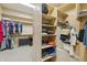 Large walk-in closet with multiple shelves, hanging rods, and drawers for clothes and shoes at 5330 S Big Horn Pl, Chandler, AZ 85249