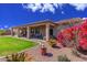 Beautiful backyard with vibrant flowers, lush grass, and a covered patio, perfect for relaxation and entertainment at 5635 W Pecan Rd, Laveen, AZ 85339