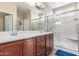 Bathroom features a double sink vanity, a glass-enclosed shower, and good lighting at 5635 W Pecan Rd, Laveen, AZ 85339