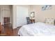 Cozy bedroom with a full-size bed, wood flooring, and adjacent closet at 5635 W Pecan Rd, Laveen, AZ 85339
