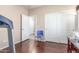 This bonus room has hardwood floors, neutral walls with cream trim, and access to the bathroom at 5635 W Pecan Rd, Laveen, AZ 85339