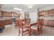 Dining area with wooden table and chairs, adjacent to the kitchen and living room at 5635 W Pecan Rd, Laveen, AZ 85339
