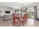 Dining area with a wooden table, chairs, and views into the living room and outdoor area at 5635 W Pecan Rd, Laveen, AZ 85339