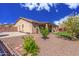 Charming backyard with a spacious lawn, covered patio, and tasteful landscaping, enhancing outdoor living at 5635 W Pecan Rd, Laveen, AZ 85339