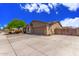 Exterior showcasing the home's architectural style, desert landscaping, and spacious driveway at 5635 W Pecan Rd, Laveen, AZ 85339