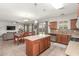 Open-concept kitchen with island and stainless appliances seamlessly flowing into the dining and living areas at 5635 W Pecan Rd, Laveen, AZ 85339
