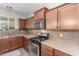 Kitchen features stainless steel oven, microwave, granite countertops, and tile backsplash at 5635 W Pecan Rd, Laveen, AZ 85339