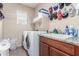 This laundry room features modern appliances, a large sink, and ample storage shelves for laundry essentials at 5635 W Pecan Rd, Laveen, AZ 85339