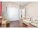 This room includes a sofa, hardwood floors, sliding closet doors, and neutral walls with cream-colored trim at 5635 W Pecan Rd, Laveen, AZ 85339