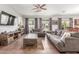 Spacious living room with ample seating, a ceiling fan, and lots of natural light at 5635 W Pecan Rd, Laveen, AZ 85339