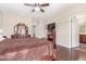 Well-lit primary bedroom showing wood flooring and an entertainment center at 5635 W Pecan Rd, Laveen, AZ 85339