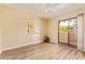 Bright bedroom with modern flooring, slider to the patio, and a ceiling fan at 5757 W Eugie Ave # 2084, Glendale, AZ 85304