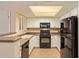 Efficient kitchen featuring black appliances, white cabinets, and tile flooring at 5757 W Eugie Ave # 2084, Glendale, AZ 85304