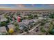 Aerial view showcasing a home with a sparkling pool, solar panels, and lush landscaping in a peaceful neighborhood at 5919 S Banning St, Gilbert, AZ 85298