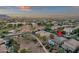 Expansive aerial view of a desert community featuring a home with a backyard pool and mountain views at 5919 S Banning St, Gilbert, AZ 85298