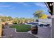Lush backyard featuring a sparkling pool, manicured lawn, and ample space for outdoor enjoyment at 5919 S Banning St, Gilbert, AZ 85298