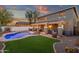 An outdoor haven featuring a sparkling pool, inviting lounge area, and a covered patio with ambient lighting at 5919 S Banning St, Gilbert, AZ 85298