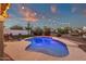 Sparkling pool and lush greenery create a serene and inviting backyard retreat with outdoor seating at 5919 S Banning St, Gilbert, AZ 85298
