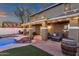 Backyard with pool, lounge chairs, and covered patio creates an inviting outdoor living area at 5919 S Banning St, Gilbert, AZ 85298