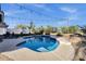 Tranquil backyard oasis featuring a sparkling pool surrounded by mature landscaping and inviting lounge chairs for relaxation at 5919 S Banning St, Gilbert, AZ 85298