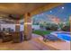Charming outdoor area with cozy seating, lush landscaping, and a pristine pool, ideal for relaxation and gatherings at 5919 S Banning St, Gilbert, AZ 85298