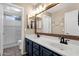 Bathroom with double sink vanity, framed mirror and shower with glass door at 5919 S Banning St, Gilbert, AZ 85298