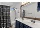 Bathroom featuring double sinks, wooden framed mirror, and shower create a serene space at 5919 S Banning St, Gilbert, AZ 85298