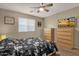 Comfortable bedroom featuring neutral walls, a ceiling fan, and natural light at 5919 S Banning St, Gilbert, AZ 85298