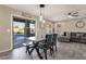 Cozy dining area with stylish seating, pendant lighting, and sliding glass doors leading to the backyard at 5919 S Banning St, Gilbert, AZ 85298